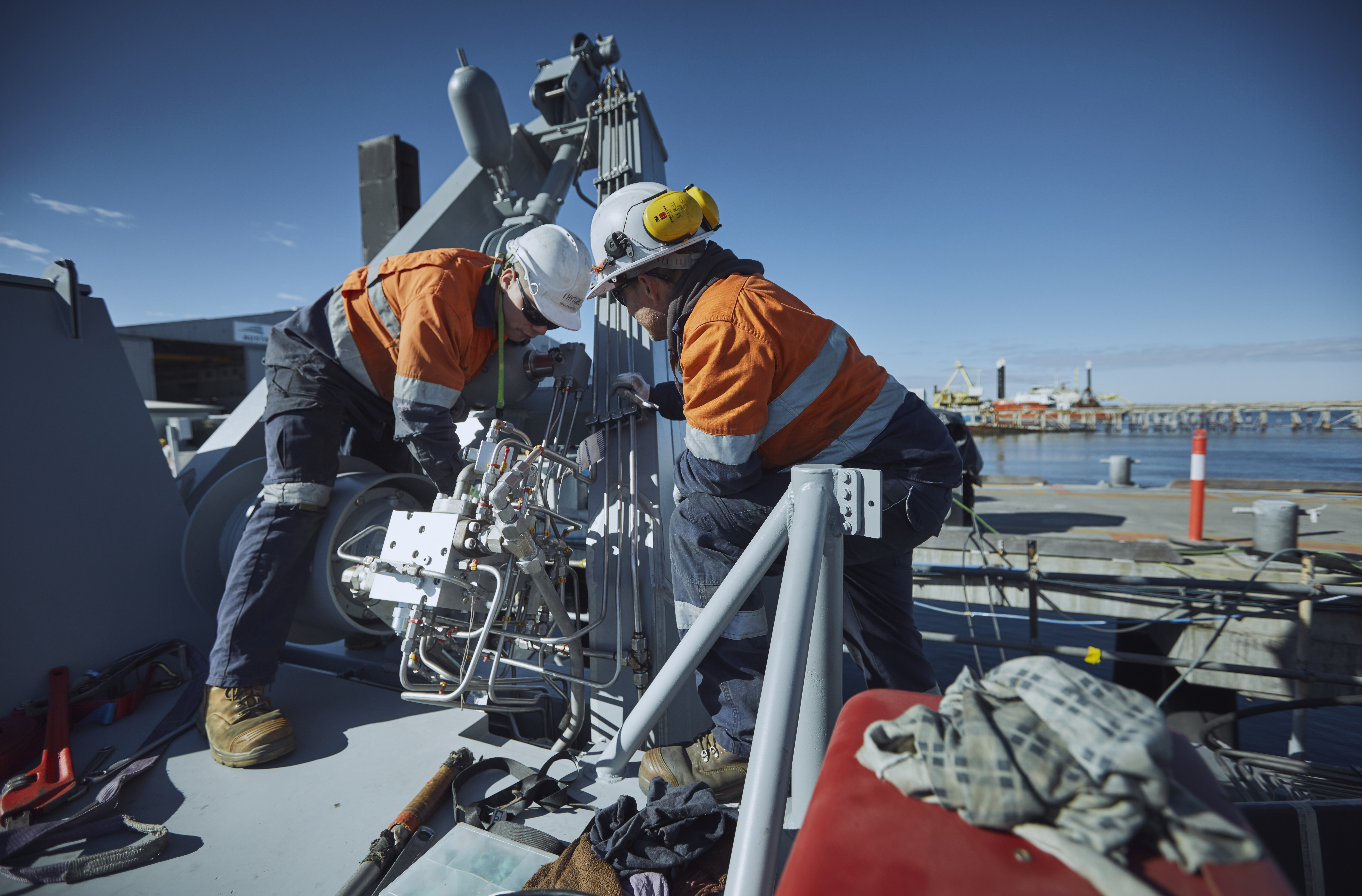 Image of two workers onboard a ship.