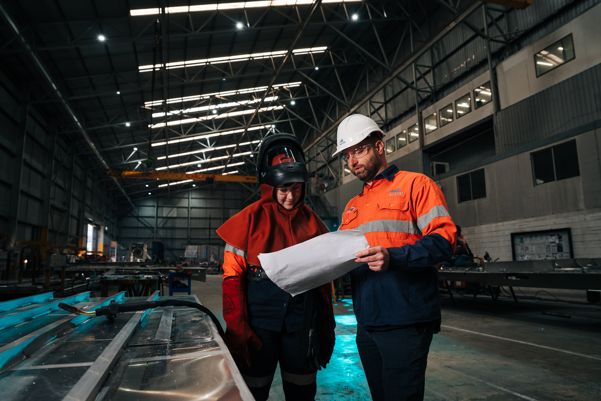 Image of Austal fabricator working with team