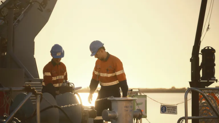 Image of Austal Australia employees working onboard a boat.