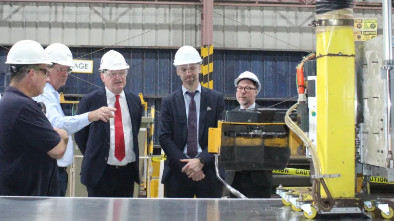 Group watching CNC machine at plate cutting for Horizon X
