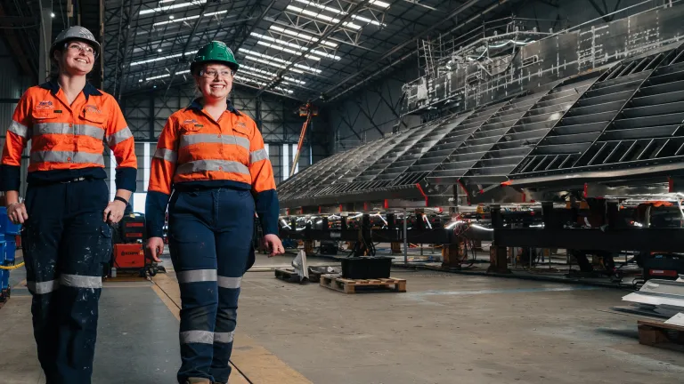 Image of Austal employees walking in production bay.